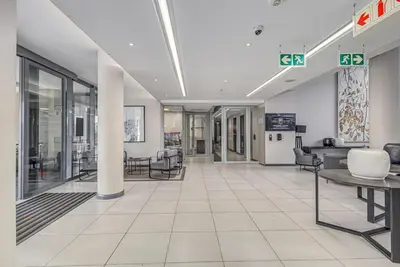an empty lobby of a hospital with chairs and tables at StayCeity at Menlyn Maine in Pretoria