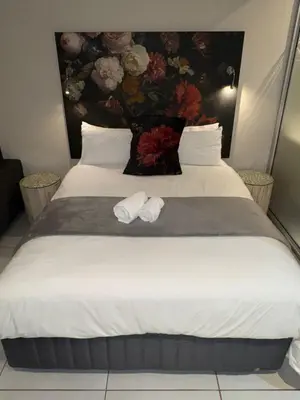 a bedroom with a bed with two towels on it at Menlyn Maine Residences 813 in Pretoria