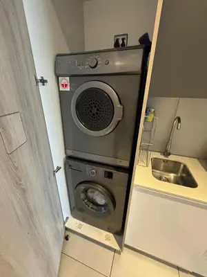 a washing machine in a kitchen with a sink at Menlyn Maine Residences 813 in Pretoria