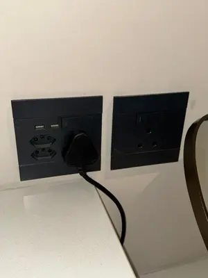 a black phone is plugged into a wall at Menlyn Maine Residences 813 in Pretoria