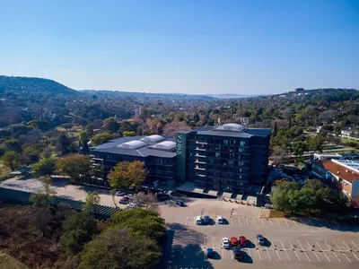 an aerial view of a building with a parking lot at Spacious Fully Equipped Studio - Peaceful-Free WiFi in Pretoria