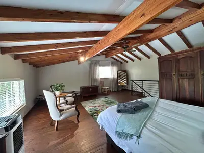 a bedroom with a bed and a chair in a room at Grace541 in Pretoria