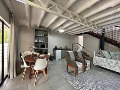 a living room with a table and a couch at Grace541 in Pretoria