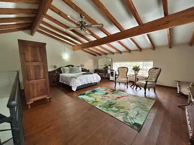 a bedroom with a bed and a table and chairs at Grace541 in Pretoria