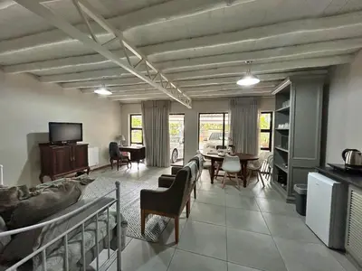 a living room with a couch and a dining room at Grace541 in Pretoria