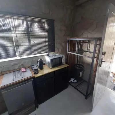 a kitchen with a microwave and a counter with a microwave at Wegpak in Barberton