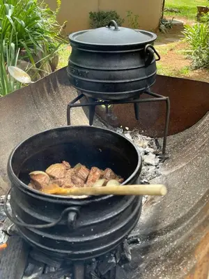 a pot of food on top of a grill at Sak n pak Kamp in Barberton