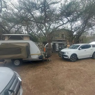 two cars parked in a parking lot with a tent at Sak n pak Kamp in Barberton