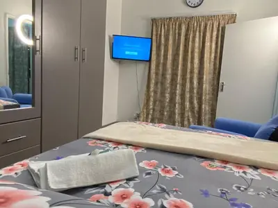 a hospital room with two beds and a tv at Fiet Star in Midrand