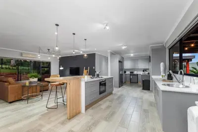 a kitchen and living room with a table and a counter at Bird of Paradise in Tzaneen