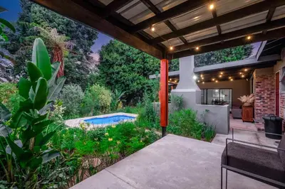 a backyard with a swimming pool and a house at Bird of Paradise in Tzaneen