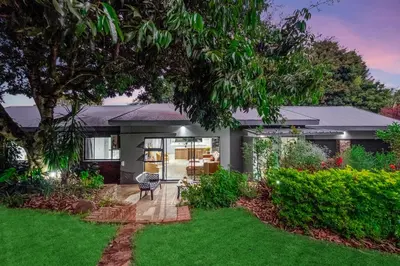 a house with a garden with a lawn at Bird of Paradise in Tzaneen