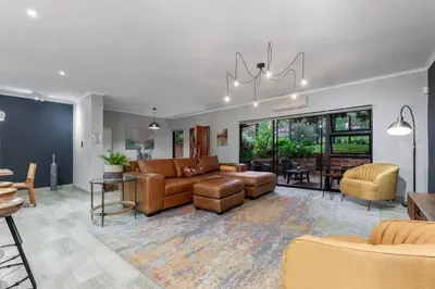 a living room with a couch and a table at Bird of Paradise in Tzaneen