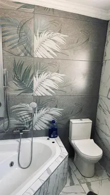 a bathroom with a toilet and a bath tub at Crown Palace Guesthouse in Pretoria
