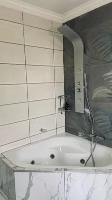 a bath tub with a faucet in a bathroom at Crown Palace Guesthouse in Pretoria