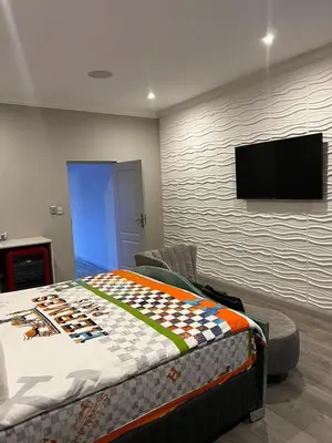 a bedroom with a bed and a flat screen tv at oliphant private House in Midrand