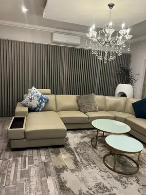 a living room with a couch and a chandelier at oliphant private House in Midrand