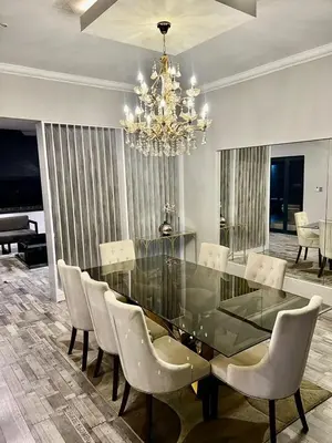 a dining room with a glass table and chairs at oliphant private House in Midrand