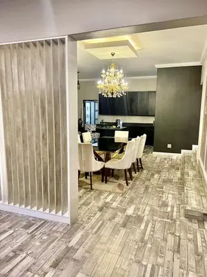 a dining room and living room with a chandelier at oliphant private House in Midrand