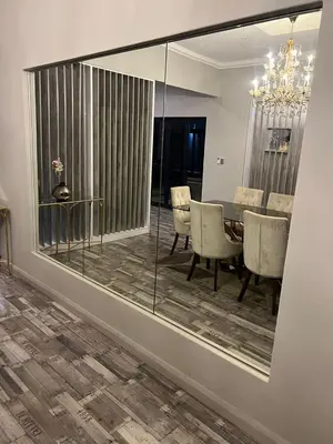 a mirror in a dining room with a table and chairs at oliphant private House in Midrand
