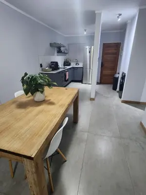 a kitchen with a wooden table with a plant on it at Vista Retreat - Stylish Flat at Menlyn Main in Pretoria