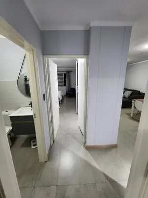 an empty room with a hallway with a mirror and a room at Vista Retreat - Stylish Flat at Menlyn Main in Pretoria
