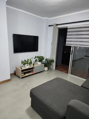 a living room with a couch and a flat screen tv at Vista Retreat - Stylish Flat at Menlyn Main in Pretoria