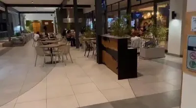 a restaurant with tables and chairs in a mall at The Blyde Crystal Lagoon in Pretoria
