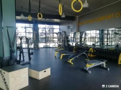 a gym with treadmills and machines in a room at The Blyde Crystal Lagoon in Pretoria