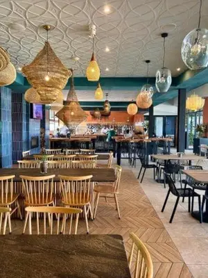a restaurant with tables and chairs and a bar at The Blyde Crystal Lagoon in Pretoria