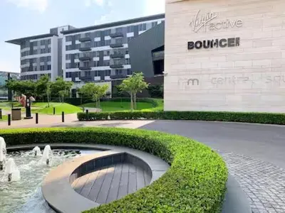 a building with a fountain in front of a building at Luxury King Studio, Menlyn Maine, Time Square Views, Smart Access in Pretoria