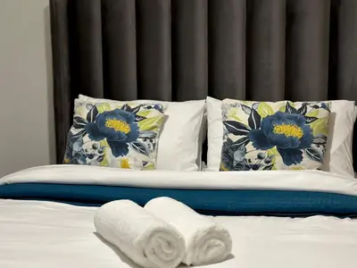 a bed with towels on it with pillows at DreamStay The Blyde Pretoria in Pretoria