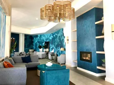 a living room with a blue accent wall at DreamStay The Blyde Pretoria in Pretoria