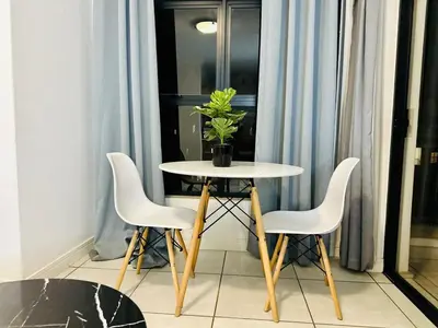 a table with three chairs and a potted plant on it at DreamStay The Blyde Pretoria in Pretoria