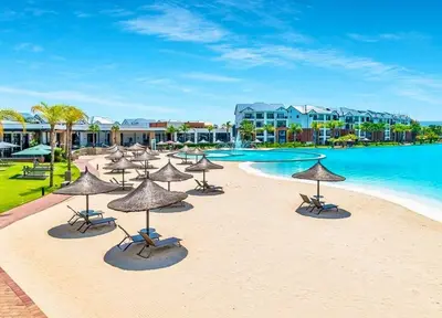 a beach with chairs and umbrellas next to the water at DreamStay The Blyde Pretoria in Pretoria