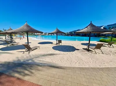 a group of chairs and umbrellas on a beach at DreamStay The Blyde Pretoria in Pretoria
