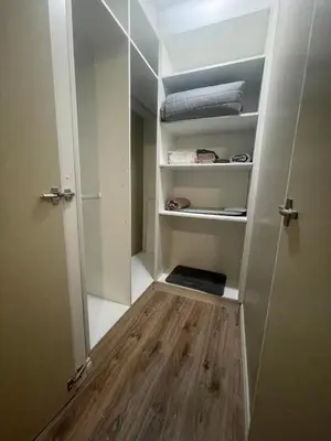 a walk in closet with a door and wooden floor at Horizon Retreat in Midrand