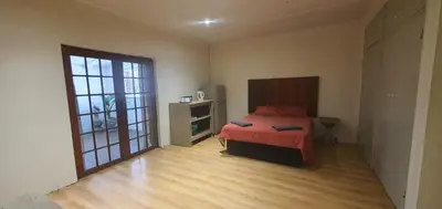 a bedroom with a bed and a large window at 329 on 30th Avenue Villieria Ashleigh in Pretoria