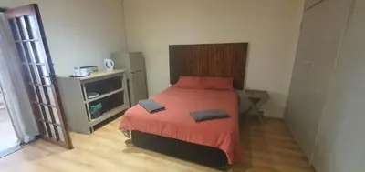a bedroom with a bed with two pillows on it at 329 on 30th Avenue Villieria Ashleigh in Pretoria