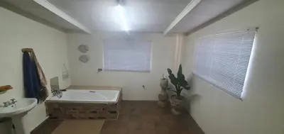 a bathroom with a bath tub and a sink at 329 on 30th Avenue Villieria Ashleigh in Pretoria