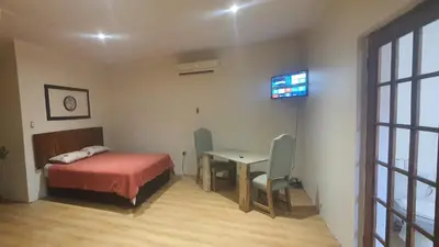 a bedroom with a bed and a desk and a table at 329 on 30th Avenue Villieria Ashleigh in Pretoria