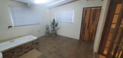a bathroom with a tub and a sink and a door at 329 on 30th Avenue Villieria Ashleigh in Pretoria