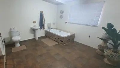 a bathroom with a tub and a toilet and a sink at 329 on 30th Avenue Villieria Ashleigh in Pretoria