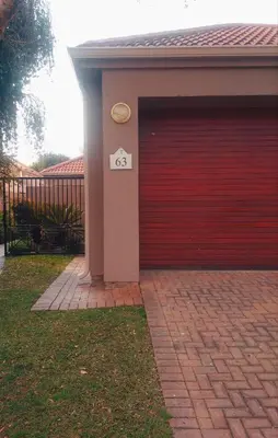 a red garage door with a sign on it at Pecanwood Haven Hartbeesport Dam in Hartbeespoort