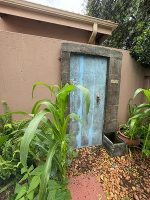 a blue door on the side of a building at Pecanwood Haven Hartbeesport Dam in Hartbeespoort