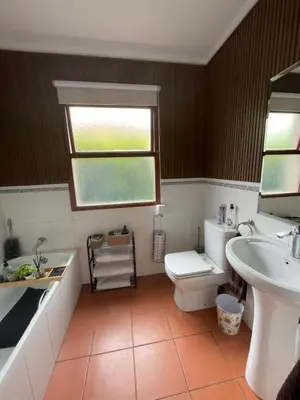 a bathroom with a toilet and a sink and a window at Pecanwood Haven Hartbeesport Dam in Hartbeespoort