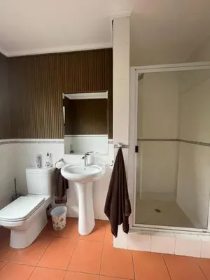 a bathroom with a toilet and a sink and a shower at Pecanwood Haven Hartbeesport Dam in Hartbeespoort
