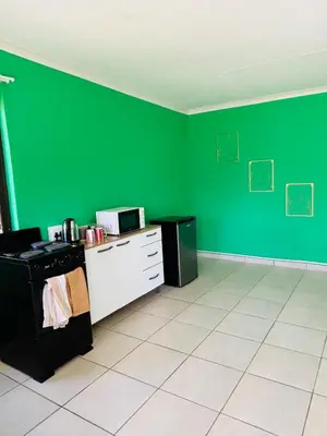 an empty kitchen with green walls and a stove at Cozy Hideout near Kruger in Hectorspruit