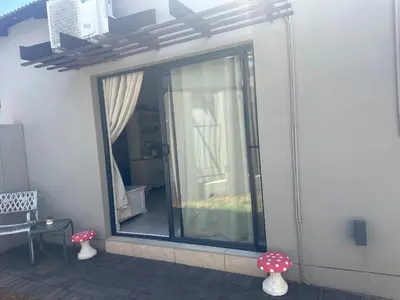 a room with a large glass window with vases at The Mush Room in Centurion