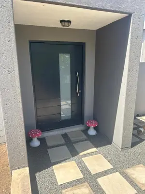 a front door of a building with two vases at The Mush Room in Centurion